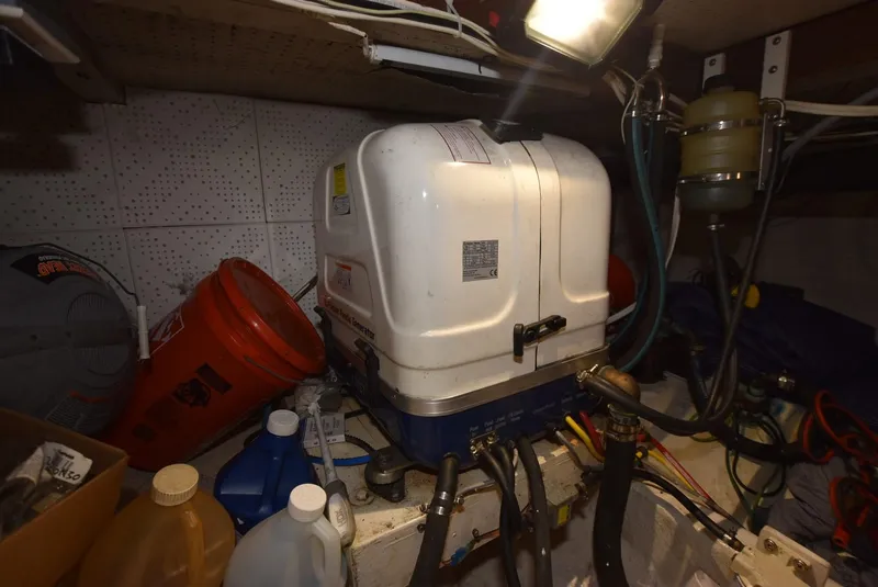 Slide: The Image of Engine room of 1983 Krogen Trawler with equipment and storage items. - 34