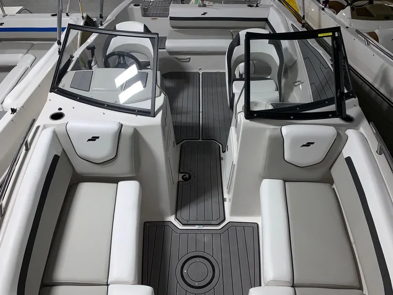 Slide: The Image of 2024 Starcraft SVX 210 boat interior with gray flooring and white seating. - 12