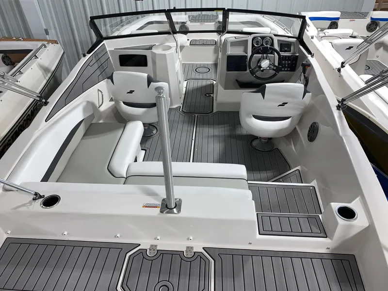 Slide: The Image of 2024 Starcraft SVX 210 boat interior with modern seating and steering console. - 13