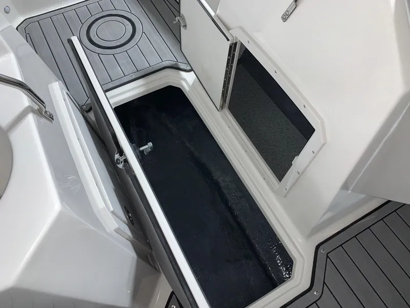 Slide: The Image of 2024 Starcraft SVX 210 boat storage compartment with open hatch. - 6