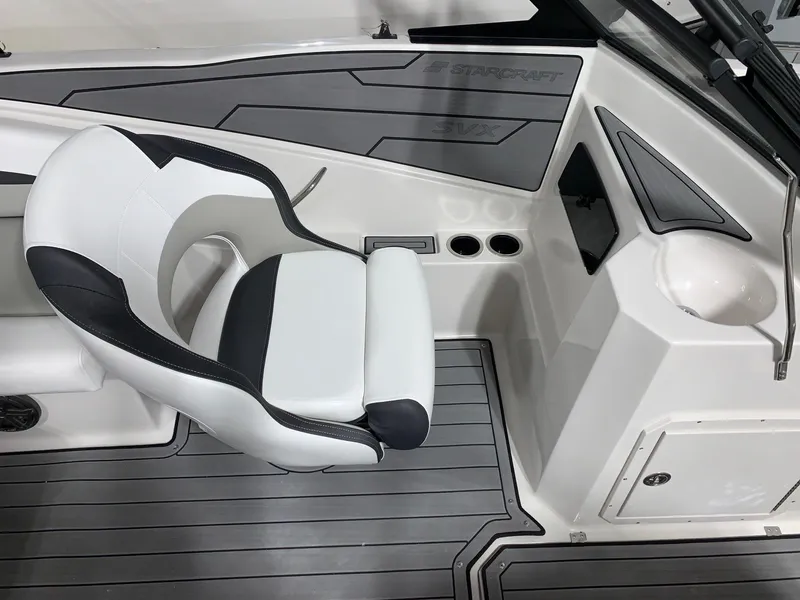 Slide: The Image of 2024 Starcraft SVX 210 boat interior with captain's chair and console. - 7