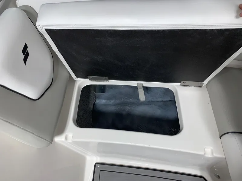 Slide: The Image of 2024 Starcraft SVX 210 boat storage compartment with open lid. - 9