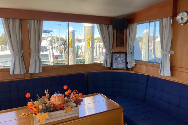 Slide: The Image of Interior of 1983 Grand Banks 42 Classic yacht with cozy seating and autumn decor. - 10
