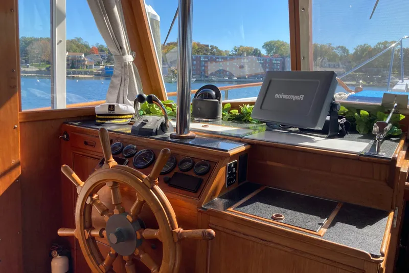 Slide: The Image of Interior helm of 1983 Grand Banks 42 Classic yacht with wooden wheel and navigation equipment. - 14