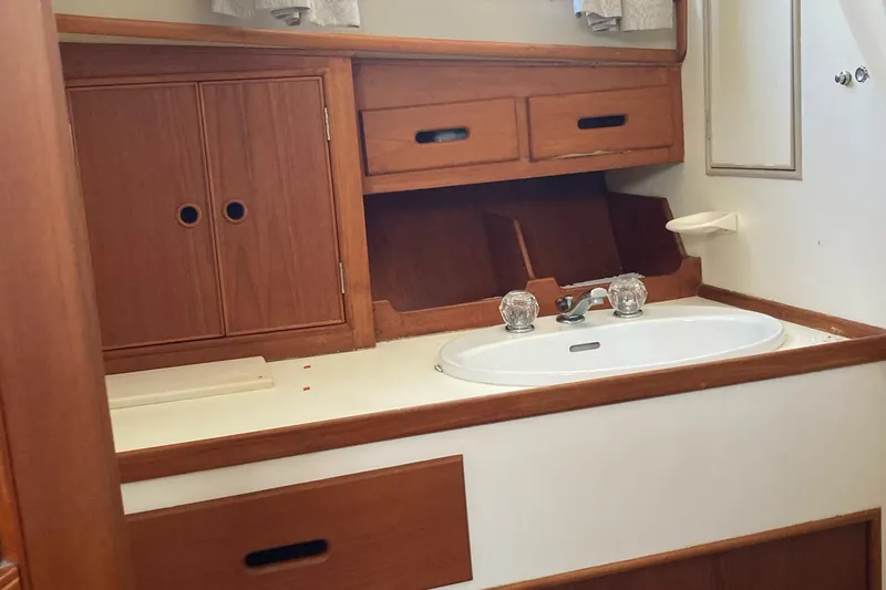 Slide: The Image of 1983 Grand Banks 42 Classic yacht bathroom with wooden cabinetry and sink. - 20