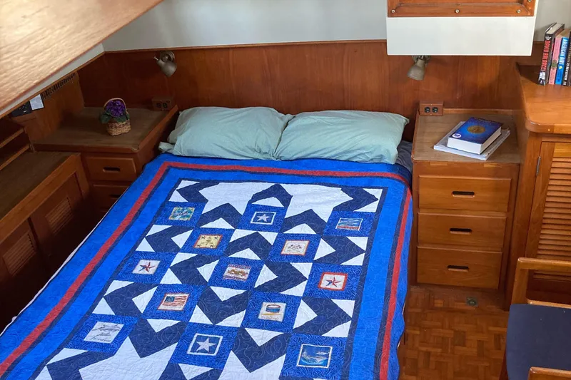 Slide: The Image of Cozy bedroom in 1983 Grand Banks 42 Classic yacht with nautical-themed quilt. - 23
