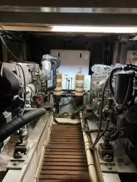 Slide: The Image of Engine room of 1983 Grand Banks 42 Classic yacht, showcasing dual engines and mechanical components. - 25