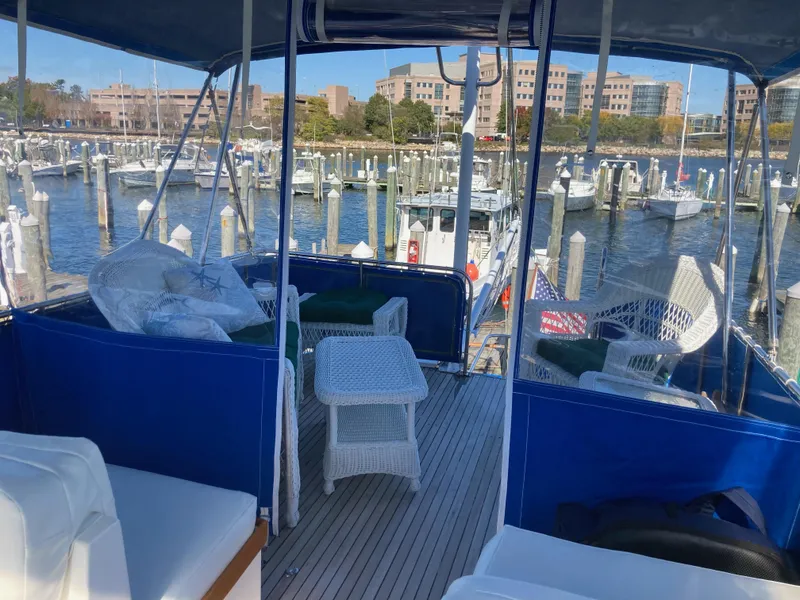 Slide: The Image of 1983 Grand Banks 42 Classic yacht interior with blue canopy, docked at marina. - 7