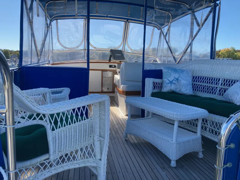 Slide: The Image of 1983 Grand Banks 42 Classic yacht with wicker seating and blue canopy. - 8