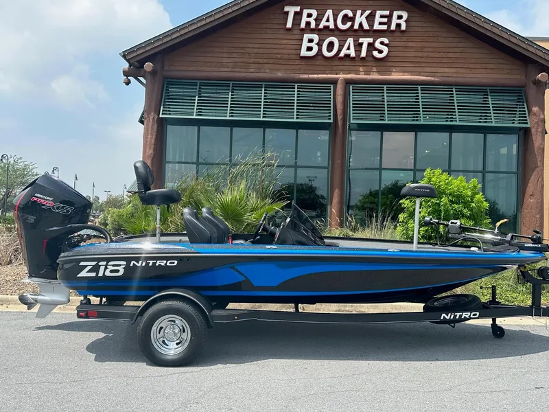 Slide: The Image of 2023 Nitro Z18 boat in front of Tracker Boats store. - 0