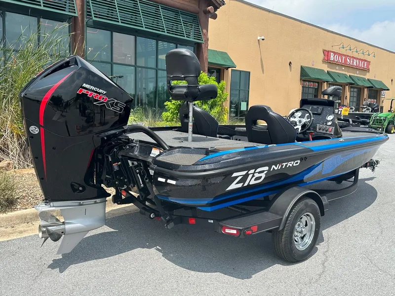 Slide: The Image of 2023 Nitro Z18 boat with Mercury Pro XS engine in front of a boat service shop. - 1
