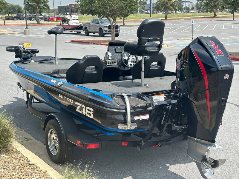 Slide: The Image of 2023 Nitro Z18 fishing boat with 175 HP engine in parking lot. - 2