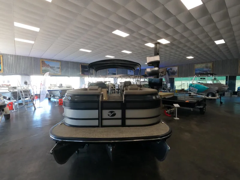 Slide: The Image of 2023 Vanderbilt 700T pontoon boat displayed in a showroom. - 21