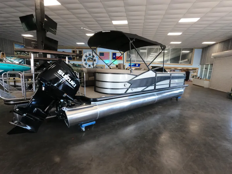Slide: The Image of 2023 Vanderbilt 700T pontoon boat with Suzuki outboard motor in showroom. - 22