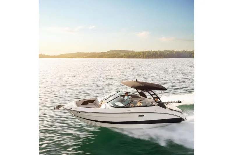 Slide: The Image of 2023 Sea Ray SLX 260 Surf boat cruising on a serene lake. - 22