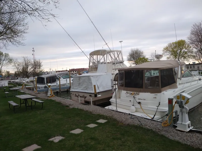 Slide: The Image of Boats docked at a marina, featuring a 1989 Egg Harbor 33 Sedan. - 18