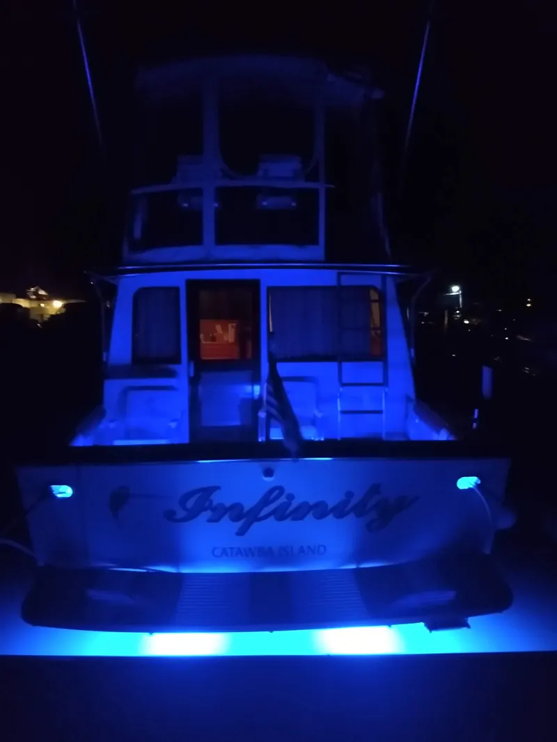 Slide: The Image of 1989 Egg Harbor 33 Sedan boat with blue LED lights at night. - 19