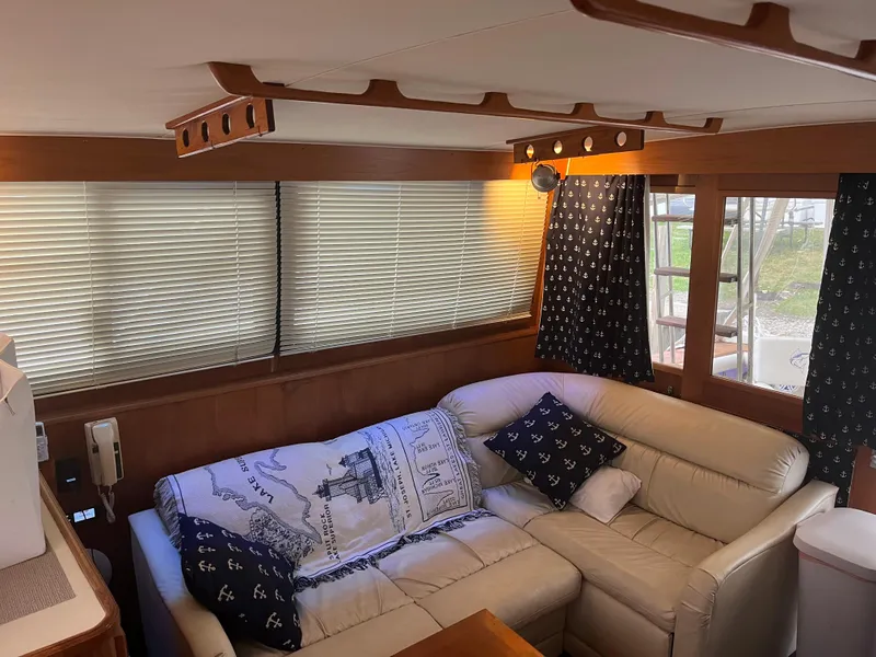 Slide: The Image of Interior of 1989 Egg Harbor 33 Sedan with beige leather sofa and nautical-themed decor. - 20
