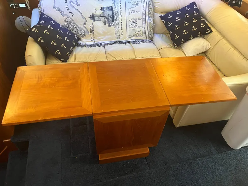 Slide: The Image of Wooden table with foldable leaves inside a 1989 Egg Harbor 33 Sedan boat interior. - 23