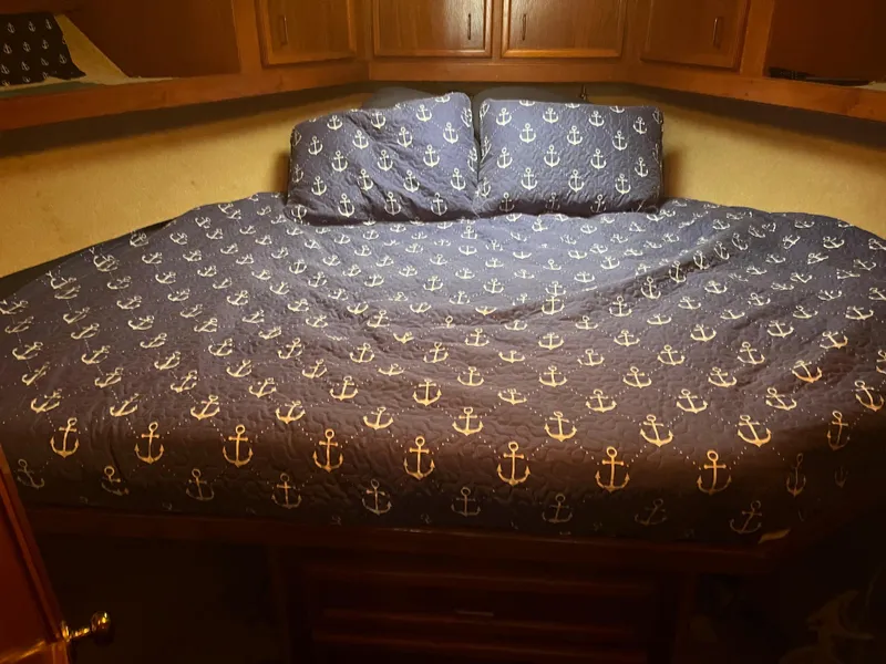 Slide: The Image of Cozy cabin bed with anchor-themed bedding in 1989 Egg Harbor 33 Sedan. - 26