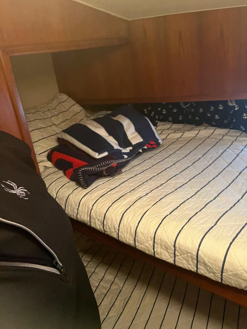 Slide: The Image of Cozy cabin interior of 1989 Egg Harbor 33 Sedan with striped bedding and wooden accents. - 28