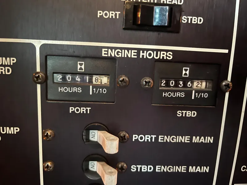 Slide: The Image of Engine hour meters on 1989 Egg Harbor 33 Sedan, showing port and starboard readings. - 31