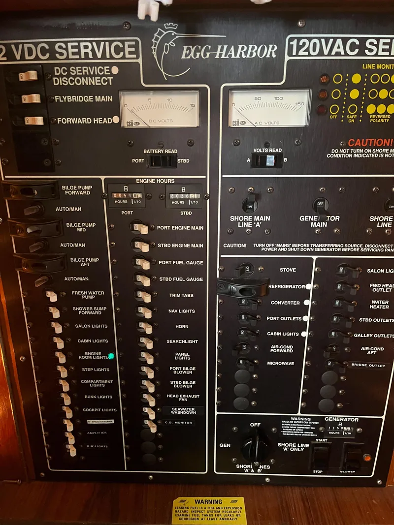 Slide: The Image of Electrical panel of a 1989 Egg Harbor 33 Sedan boat, showing 12VDC and 120VAC service controls. - 32