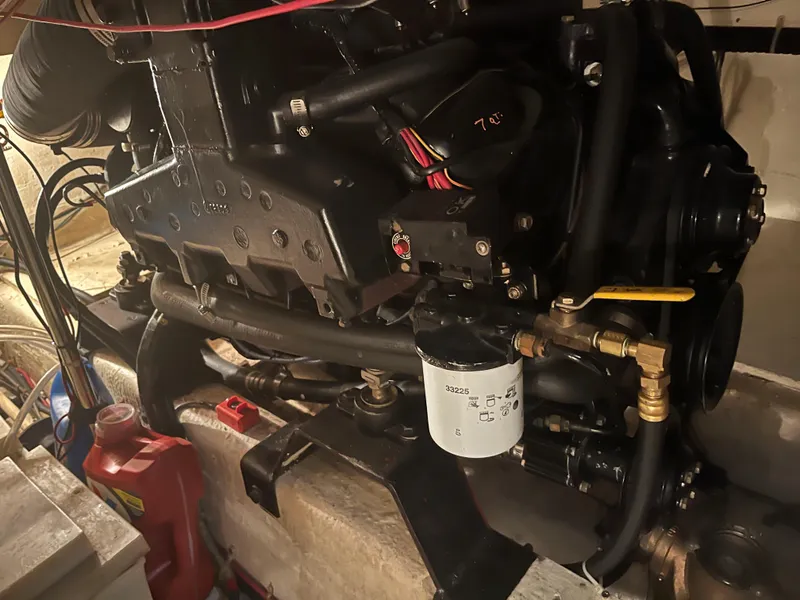 Slide: The Image of Engine of 1989 Egg Harbor 33 Sedan boat, showcasing mechanical components and filter. - 34