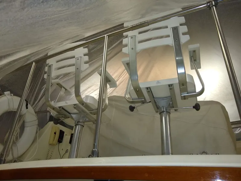 Slide: The Image of 1989 Egg Harbor 33 Sedan boat with two white swivel chairs on deck. - 39