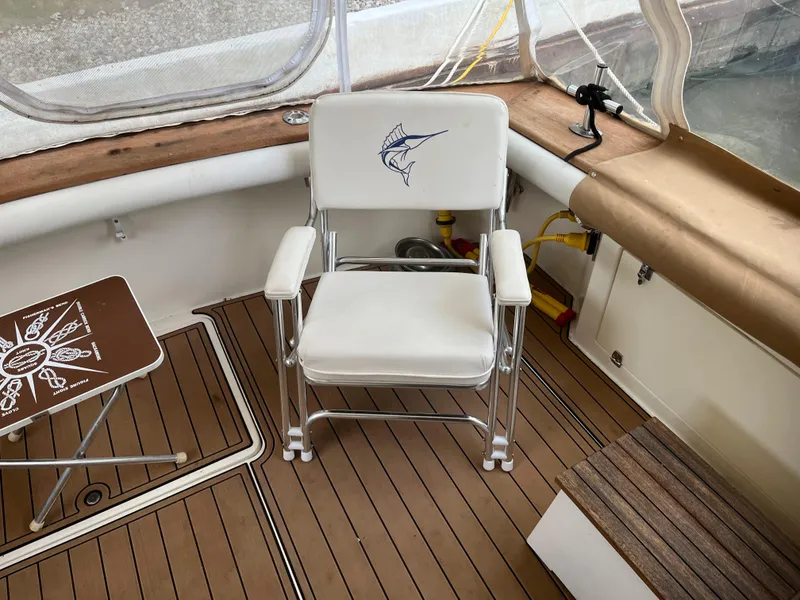 Slide: The Image of 1989 Egg Harbor 33 Sedan interior with fishing chair and teak flooring. - 8