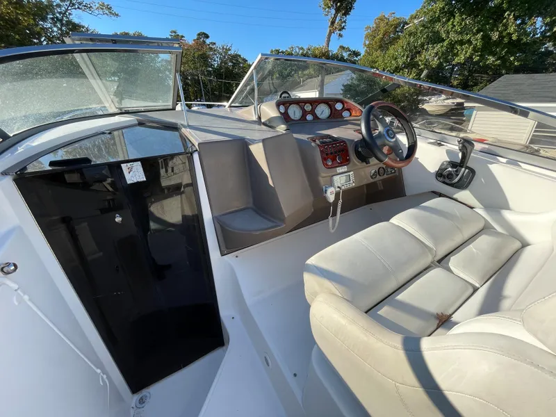 Slide: The Image of 2006 Regal 2665 Commodore boat cockpit with steering wheel and seating. - 12