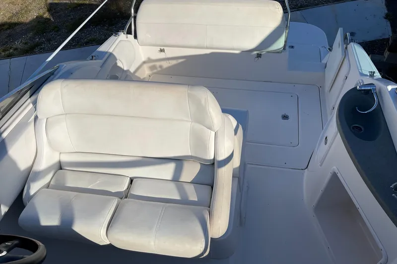 Slide: The Image of 2006 Regal 2665 Commodore boat interior with white seating. - 13