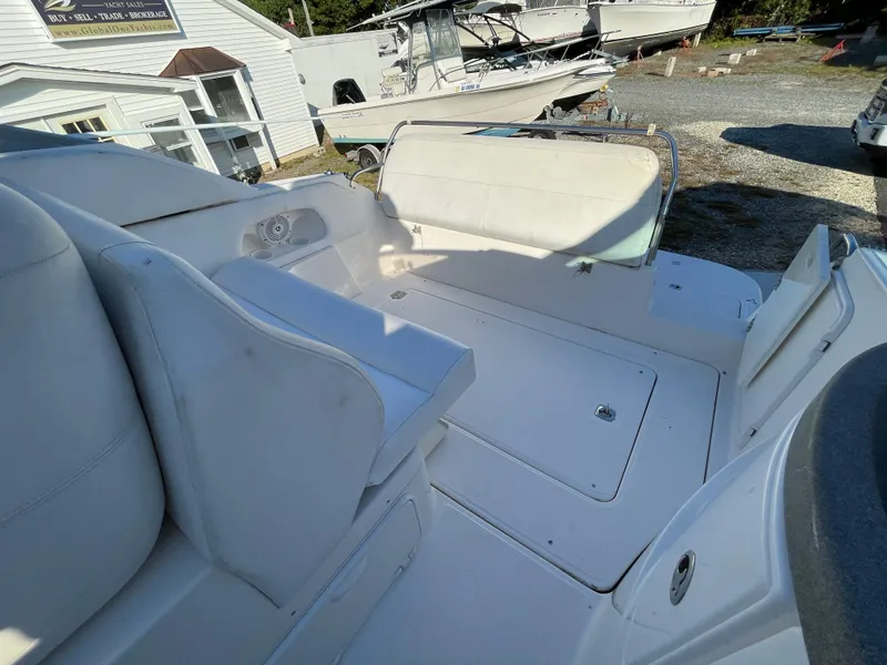 Slide: The Image of 2006 Regal 2665 Commodore boat interior with white seating and deck. - 15