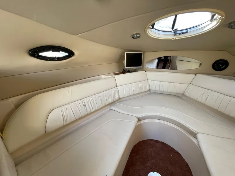 Slide: The Image of Interior cabin of a 2006 Regal 2665 Commodore boat with beige seating. - 18