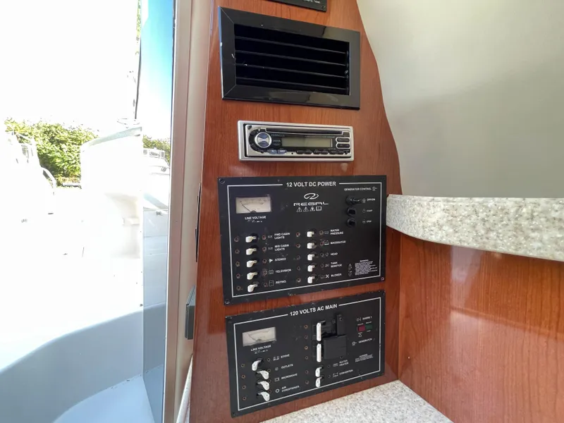 Slide: The Image of Control panel and stereo system inside a 2006 Regal 2665 Commodore boat. - 19
