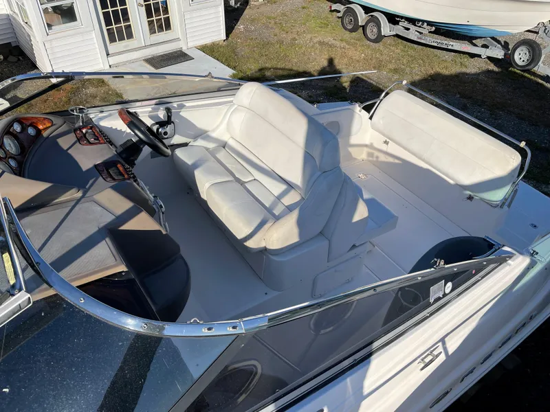 Slide: The Image of 2006 Regal 2665 Commodore boat interior with white seating and dashboard. - 24