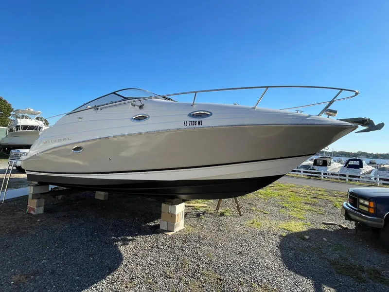 Slide: The Image of 2006 Regal 2665 Commodore boat on dry dock under clear blue sky. - 6