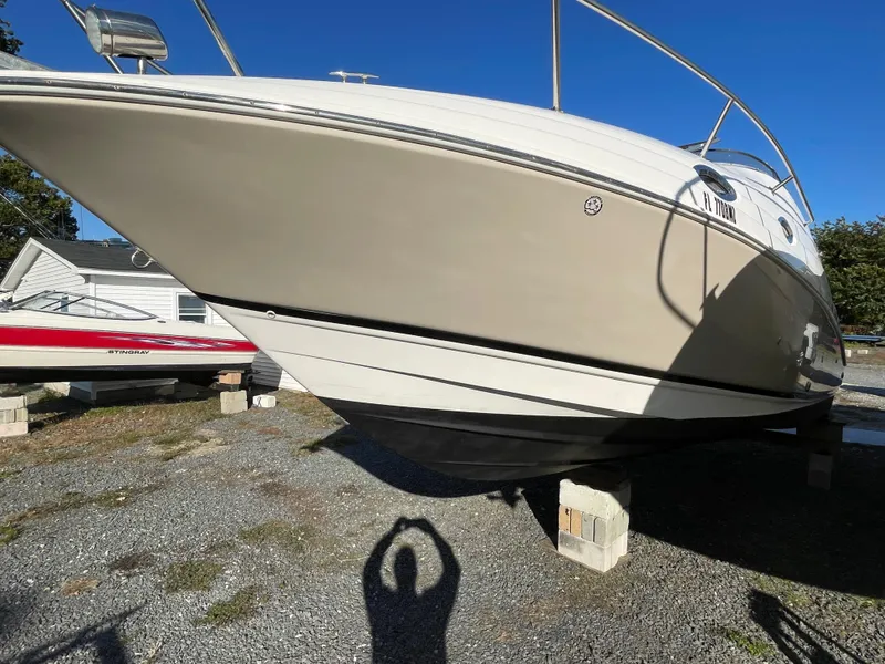 Slide: The Image of 2006 Regal 2665 Commodore boat on blocks in a yard. - 7