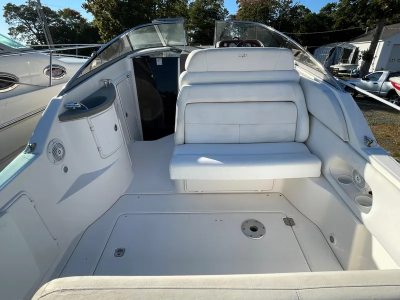 Slide: The Image of 2006 Regal 2665 Commodore boat interior with white seating and clean deck. - 8