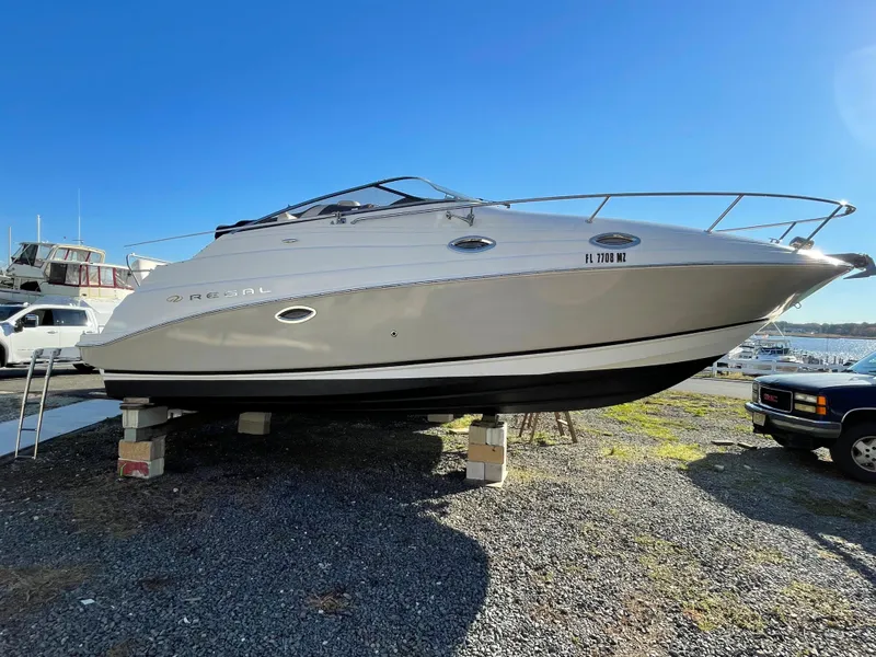 Slide: The Image of 2006 Regal 2665 Commodore boat on dry dock under clear blue sky. - 9