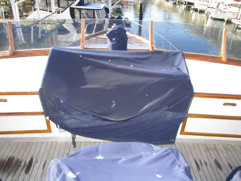 Slide: The Image of 1984 McQueen Flush Deck Motoryacht with covered helm, docked at marina. - 16