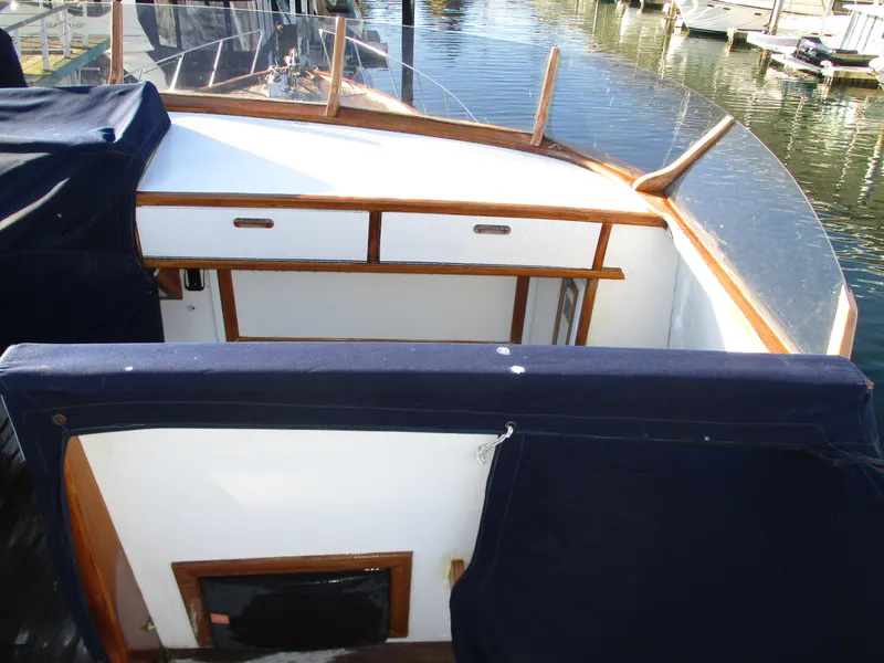 Slide: The Image of 1984 McQueen Flush Deck Motoryacht interior with wooden accents and blue upholstery. - 17