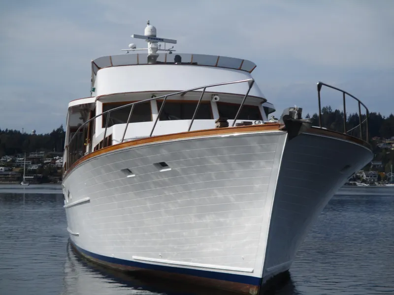 Slide: The Image of 1984 McQueen Flush Deck Motoryacht on calm water, showcasing elegant design and craftsmanship. - 3