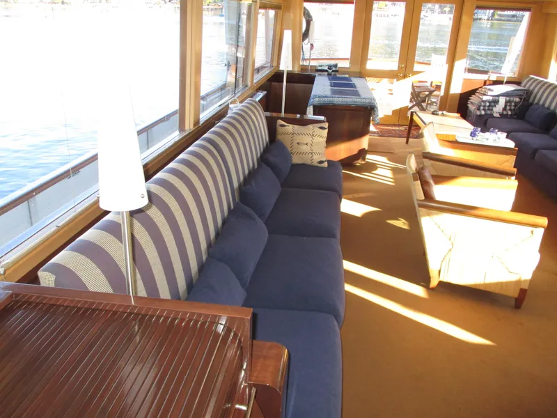 Slide: The Image of Luxurious interior of 1984 McQueen Flush Deck Motoryacht with striped seating and panoramic windows. - 36