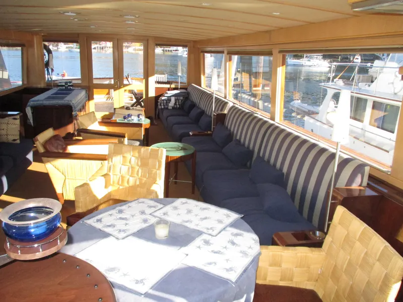 Slide: The Image of Luxurious interior of 1984 McQueen Flush Deck Motoryacht with striped seating and waterfront view. - 37