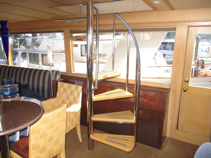 Slide: The Image of Interior of 1984 McQueen Flush Deck Motoryacht with spiral staircase and elegant seating area. - 40