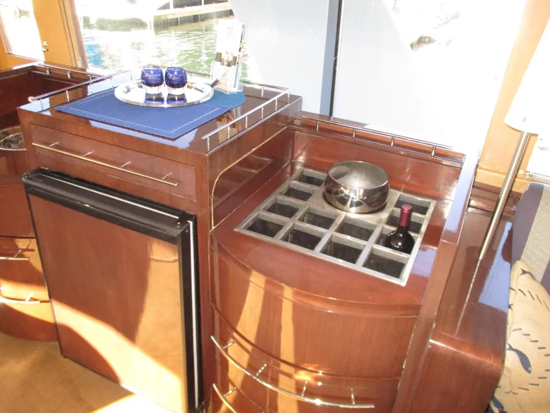 Slide: The Image of Luxurious 1984 McQueen Flush Deck Motoryacht interior with elegant wooden cabinetry and wine storage. - 42