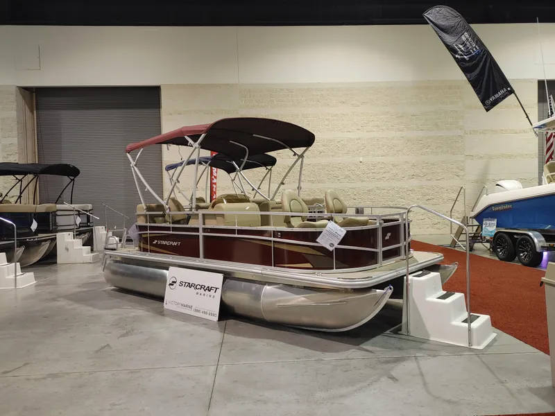 Slide: The Image of 2024 Starcraft EX 18 F pontoon boat on display indoors. - 4
