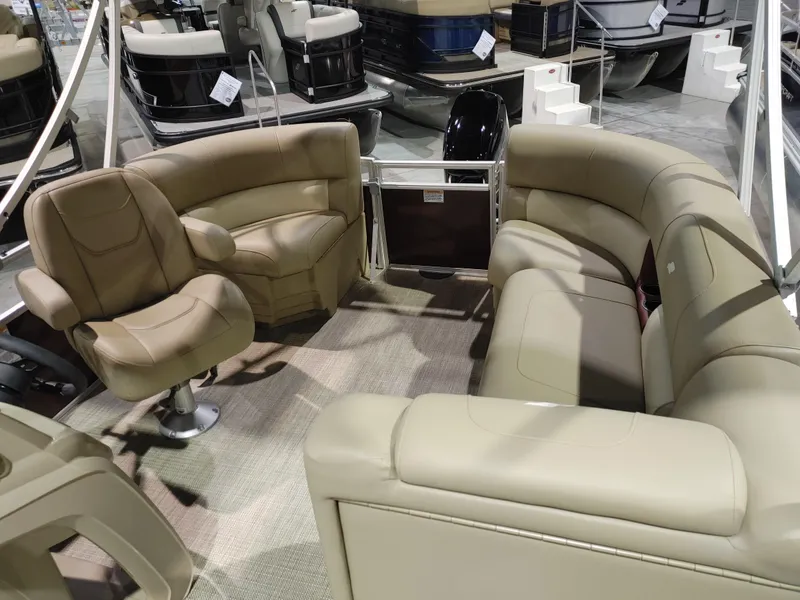 Slide: The Image of 2024 Starcraft EX 18 F pontoon boat interior with beige seating. - 6