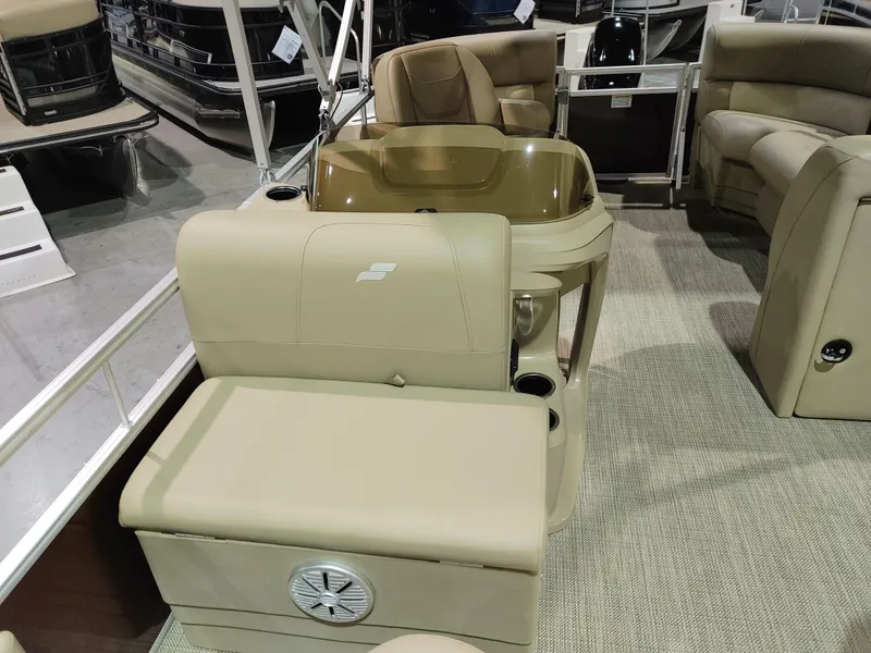 Slide: The Image of 2024 Starcraft EX 18 F pontoon boat interior with beige seating and console. - 8